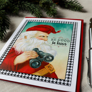 a christmas card with a santa clause holding a camera