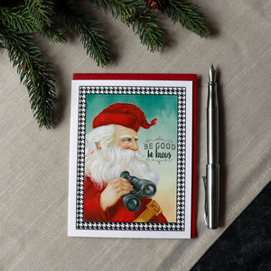 a christmas card with a picture of santa holding a camera