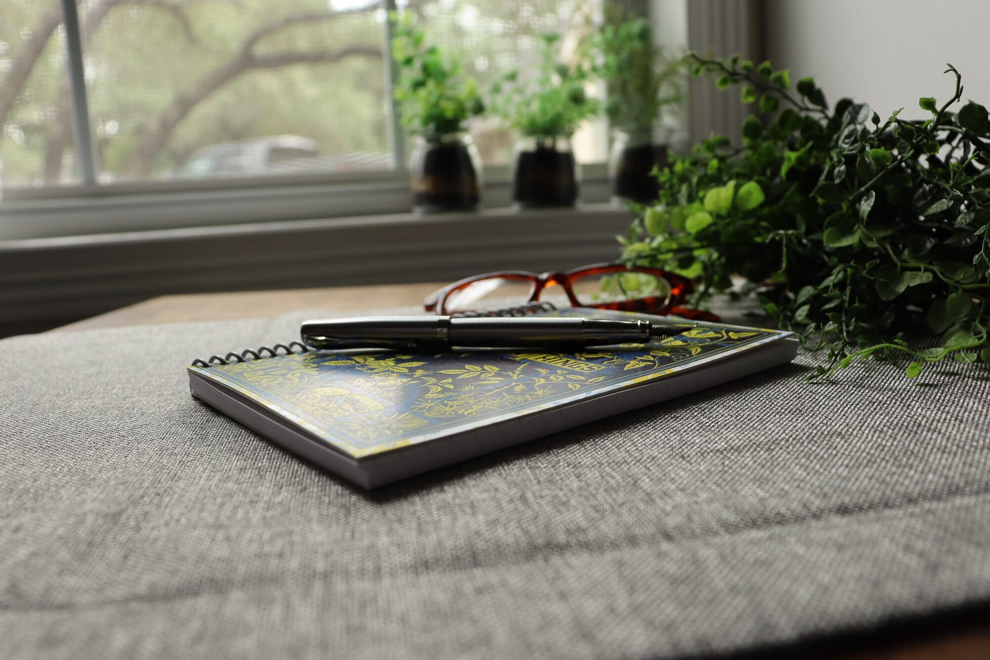 handmade travel notebook (5&quot; x 7&quot;) featuring a vintage book cover, Beauty in Common Things. Colors: navy blue, yellow, white, and light blue. Floral Patterns.