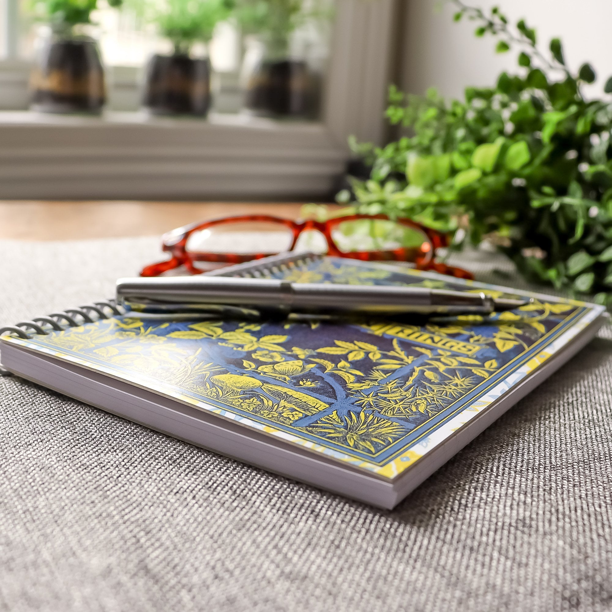 handmade travel notebook (5&quot; x 7&quot;) featuring a vintage book cover, Beauty in Common Things. Colors: navy blue, yellow, white, and light blue. Floral Patterns.