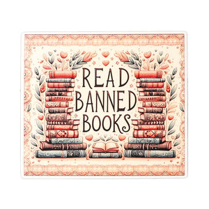 This is an image of a rectangular vinyl water resistant sticker featuring the phrase "Read Banned Books". A vintage style illustration features the phrase between two stacks of books and various flowers and hearts. Colors are feminine: a cream background with accents of soft green, brown, peach and blue.